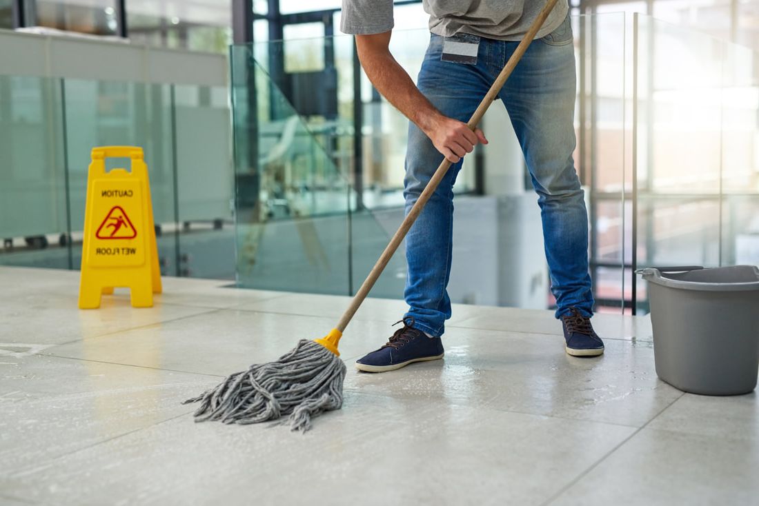 janitor mopping office building floors